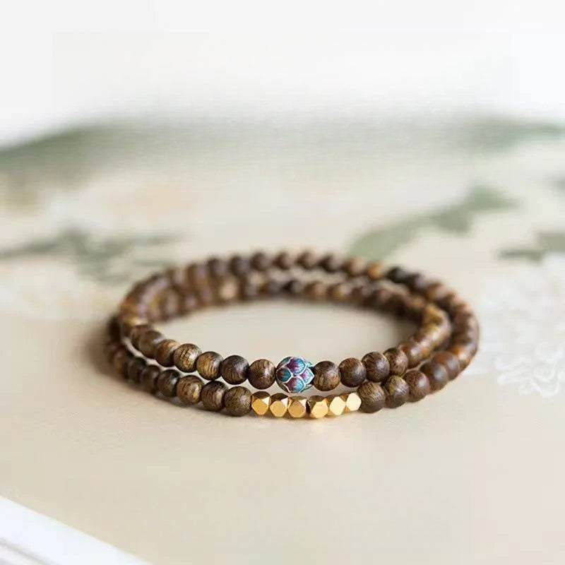 Sandalwood bracelet stacked with three rings of 6mm calming and stable bracelet