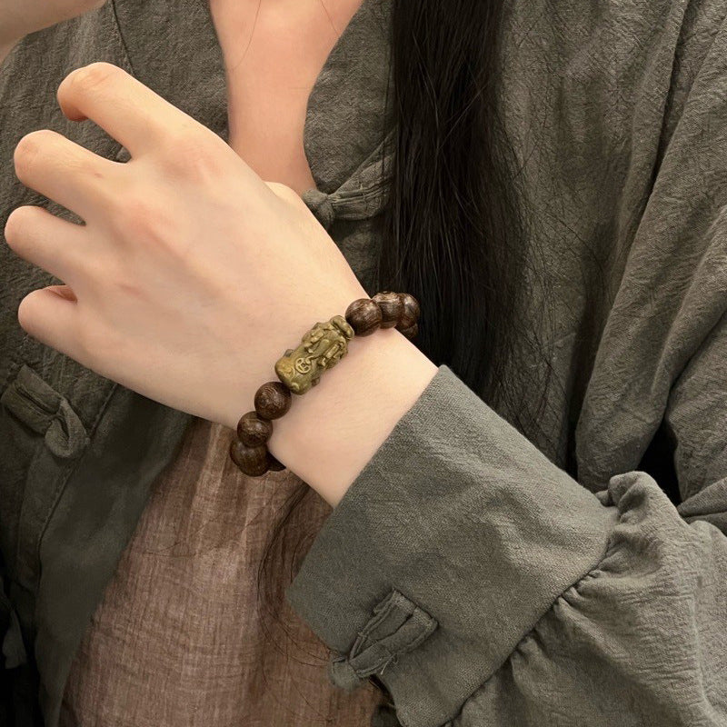 Pixiu bracelet made of golden silk sandalwood.