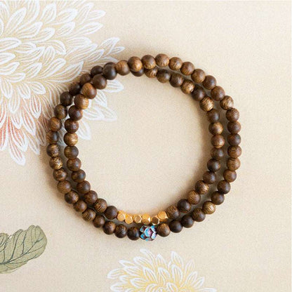 Sandalwood bracelet stacked with three rings of 6mm calming and stable bracelet